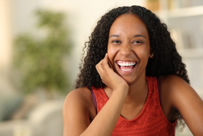 A smiling woman after undergoing professional teeth whitening treatment in Portage, MI
