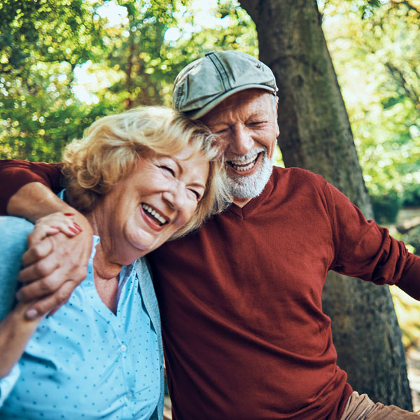 senior man and woman laughing outdoors